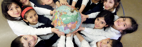 Kids holding a globe
