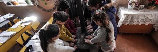 Artsakh Kids around a wood heater