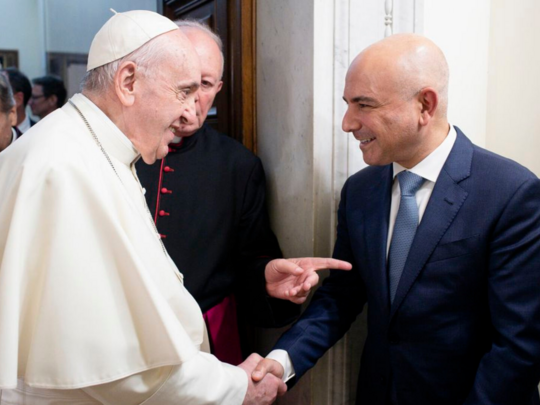 Pope Francis shaking Dr. Eric Esrailian's hand after recognizing his service with the prestigious Benementi medal.